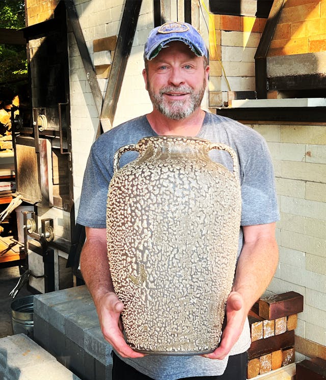 picture of Donald Reed holding one his pottery peices